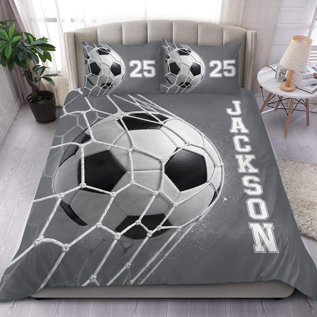 Soccer duvet cover set displayed on a bed with a grayscale ball, net design, and bold bedroom lettering
