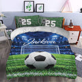 Soccer duvet cover set in a bedroom with stadium lights, goal net, green field, and soccer ball artwork
