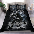 Black hockey duvet cover set displayed on a bed with an ice hockey player, rink scene, bold number, and custom lettering
