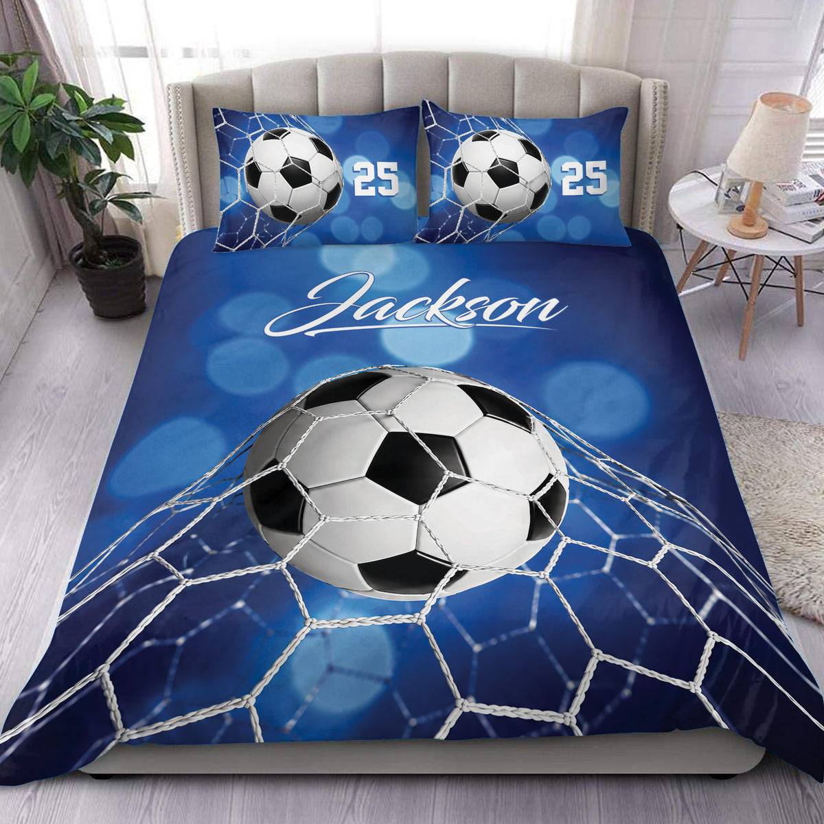 Blue soccer duvet cover set displayed on a bed with soccer balls, goal net artwork, and matching pillows