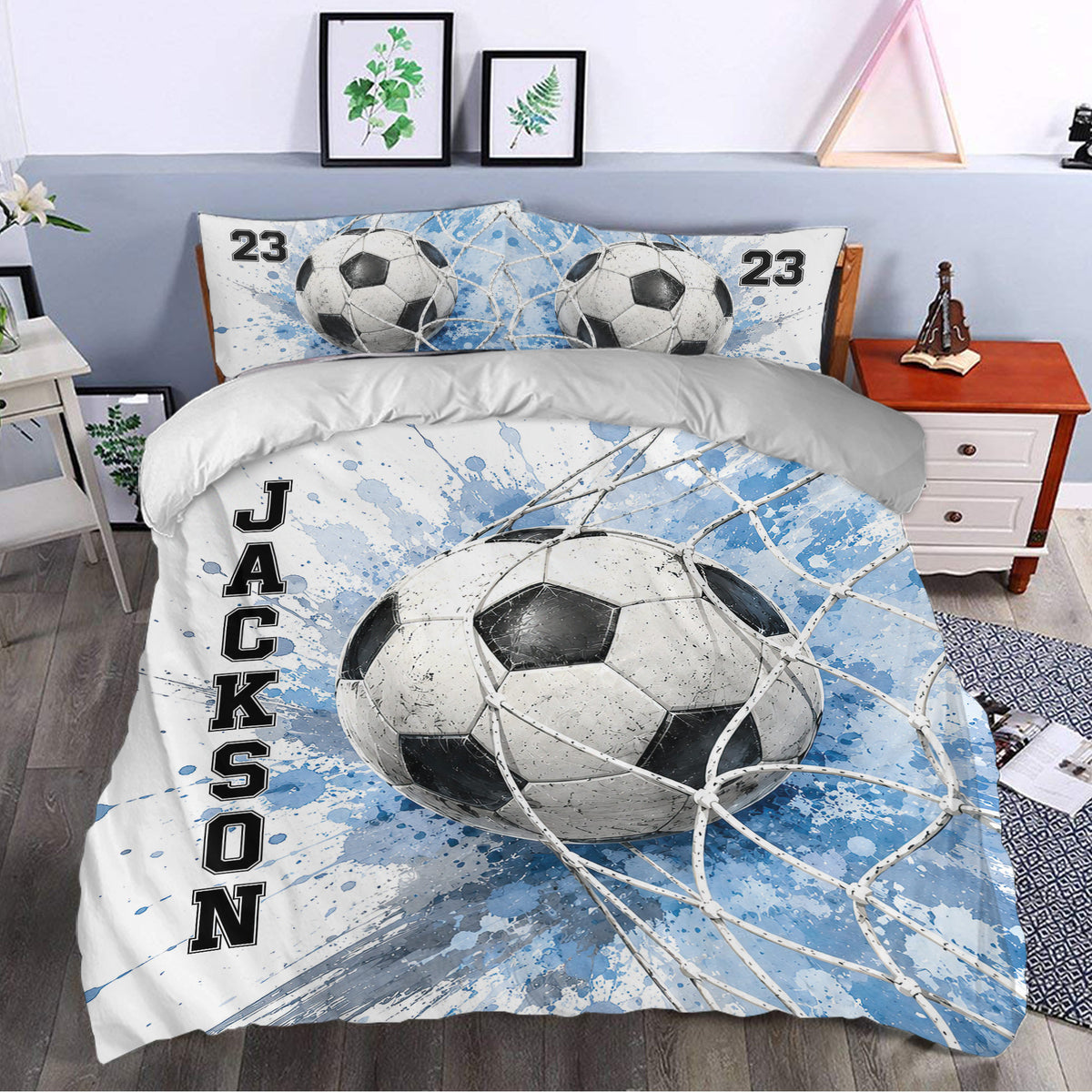 Soccer duvet cover set styled in a bedroom with large ball graphics and blue athletic artwork