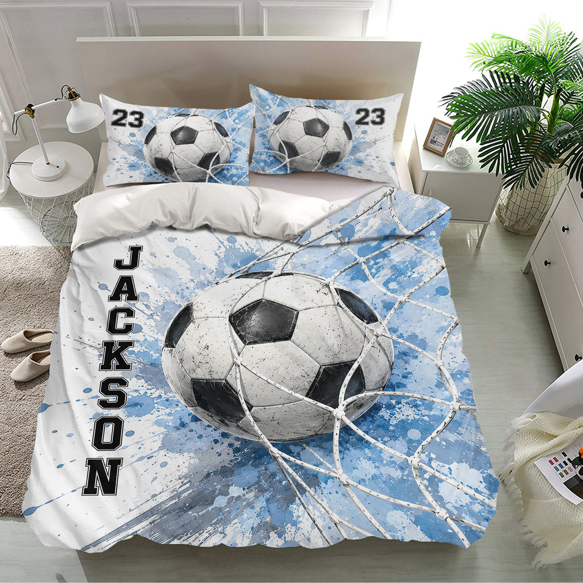 Blue soccer bedding set displayed in a bright bedroom with matching pillowcases and ball artwork