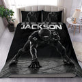 Black football duvet cover set displayed on a bed with matching player artwork on the pillowcases