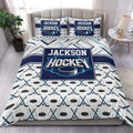 Hockey duvet cover set displayed on a bed with navy, white, gray, and cyan hockey artwork