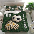 Soccer bedding set in a bright bedroom featuring green field artwork, soccer balls, and goalkeeper gloves