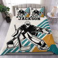 Hockey goalie duvet cover set displayed on a bed with teal, gold, black, and white graphics