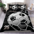 Black and white soccer duvet cover set displayed on a modern bedroom bed with matching ball artwork