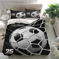 Modern soccer bedroom decor featuring a black duvet cover set with oversized soccer ball design