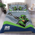 Lacrosse duvet cover set displayed on a bed with green player artwork, crossed sticks, blue accents, and bold athletic styling