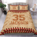 Baseball duvet cover set displayed on a bed with tan leather texture, red stitching, and bold jersey-style artwork