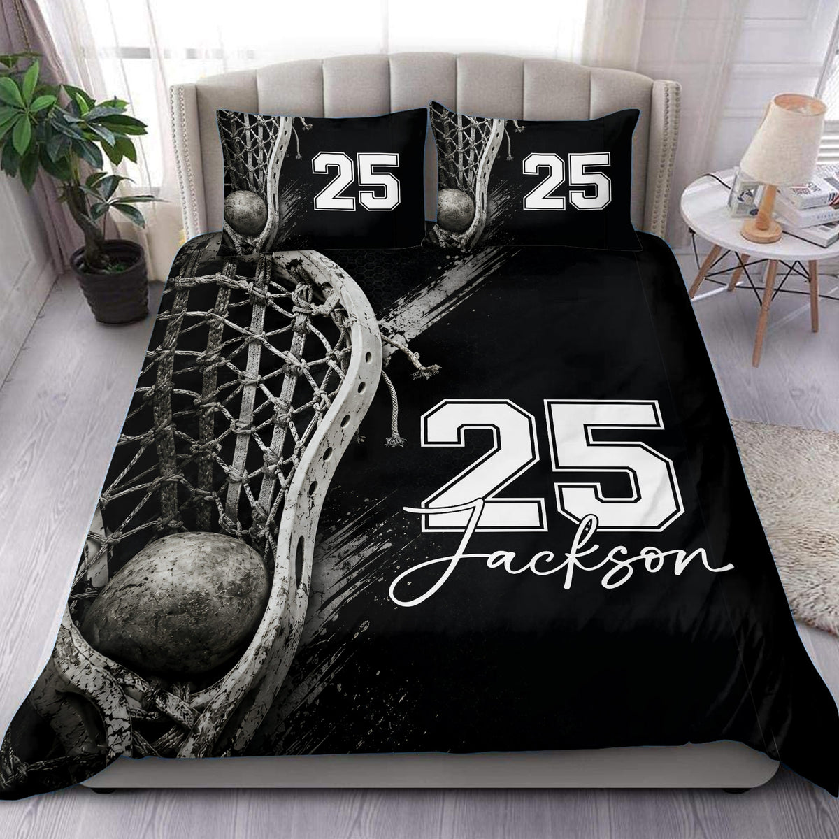 Black lacrosse duvet cover set displayed on a bed with dramatic stick, net, ball, and bold lettering artwork
