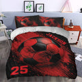 Red and black soccer duvet cover styled in a bedroom with dramatic ball artwork and sports decor