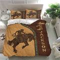 Rodeo bedding set displayed in a bright bedroom with bronc rider artwork, cowboy boot, and Western brown tones