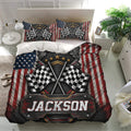 Motorsport-inspired racing bedding set displayed in a bright bedroom with crossed checkered flags and metallic artwork