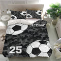 Black camouflage soccer duvet cover set displayed in a bright bedroom with matching soccer ball pillowcases