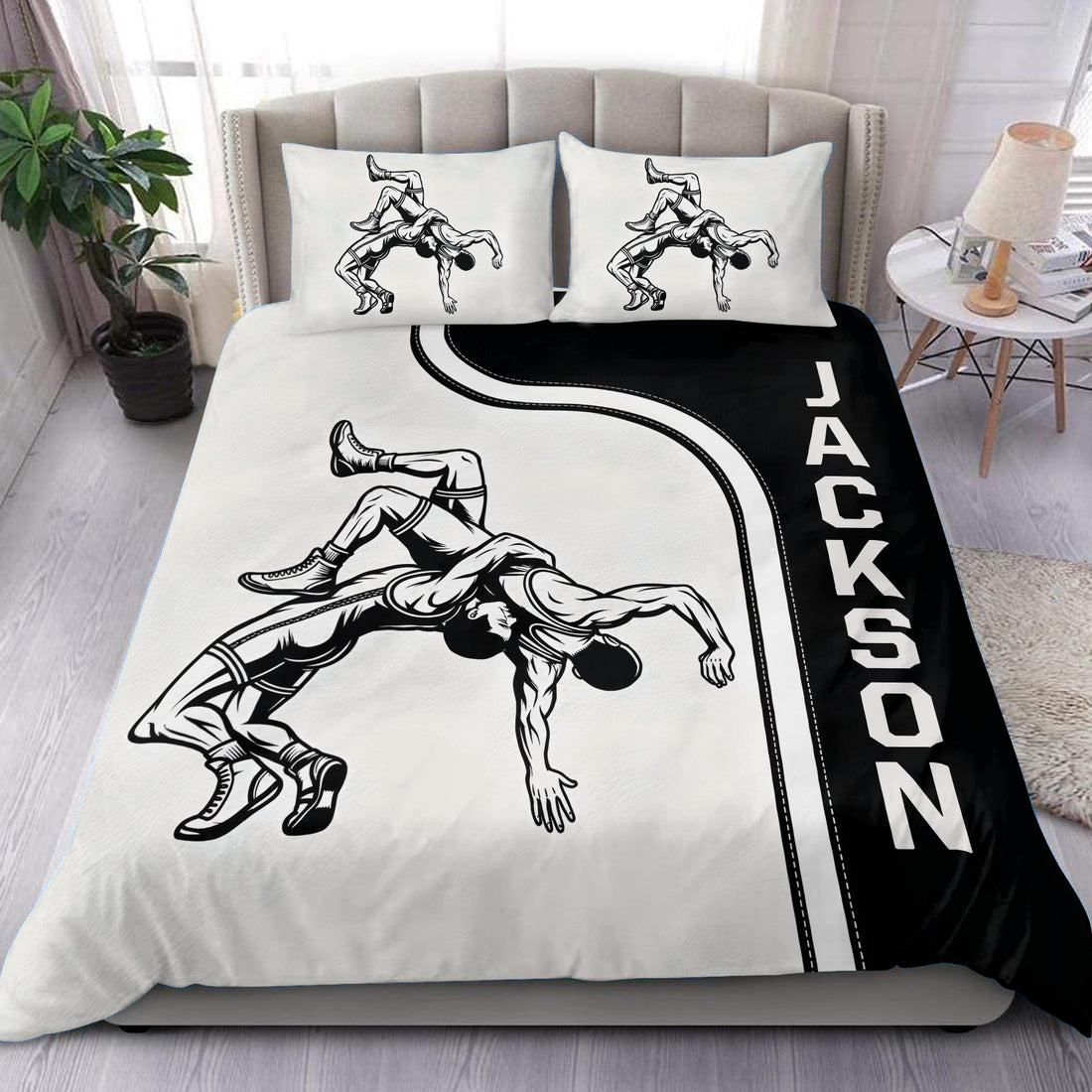 Black and white wrestling duvet cover set styled on a modern bed with grappling artwork and bold side lettering