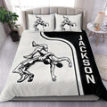 Black and white wrestling duvet cover set styled on a modern bed with grappling artwork and bold side lettering
