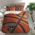 Basketball bedding set presented in a bright bedroom with matching pillows and an orange textured design