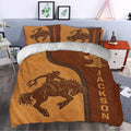 Rodeo duvet cover styled in a bedroom with cowboy rider artwork, western boots, and rustic brown tones