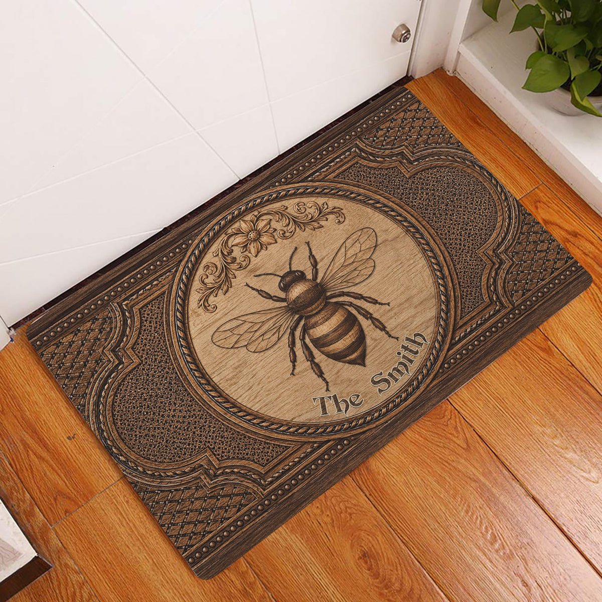 Bee doormat displayed in an entryway on warm wood flooring beside a white door