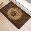 Brown bee entryway mat styled near a doorway, featuring ornate borders and botanical detailing