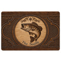 Rustic fishing doormat featuring a detailed fish illustration, ornate woodgrain border, and compass motif