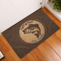 Fishing-themed doormat displayed in an entryway on a warm wood floor beside a door
