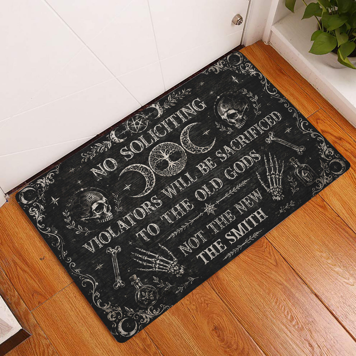 Wicca doormat displayed in an entryway with moon, skull and ritual-inspired artwork