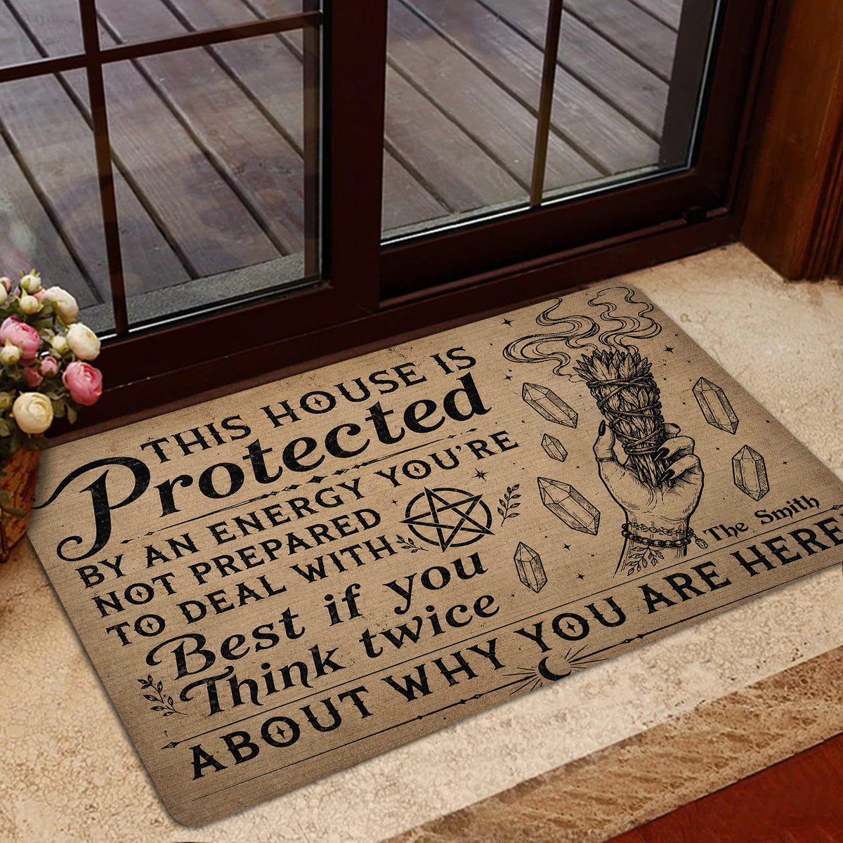 Witchcraft-inspired doormat styled near a glass door with protective symbols and cleansing bundle artwork