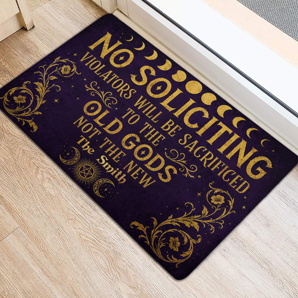 Purple and gold Wicca door mat placed beside an entrance with moon phases and pentagram