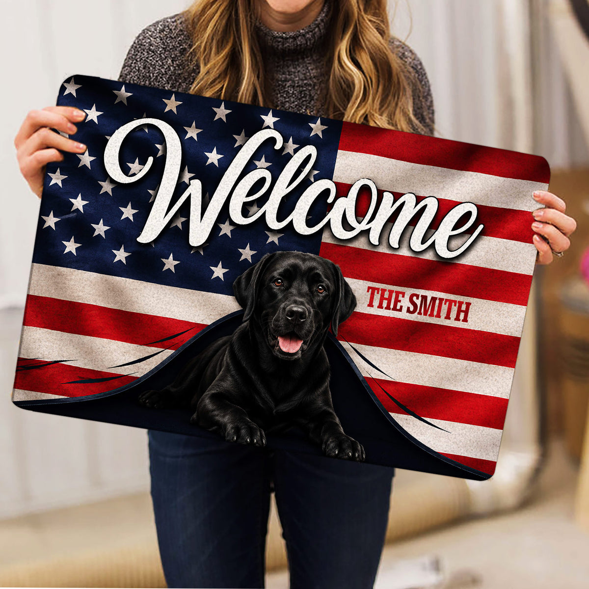 Labrador Retriever doormat held indoors, showing the patriotic welcome design