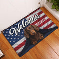 Patriotic dachshund welcome doormat displayed at a home entrance on a warm wood floor