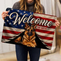 Person holding a German Shepherd doormat featuring a patriotic flag design and welcoming artwork