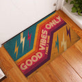Colorful rock and roll doormat displayed at an indoor doorway on warm wood flooring