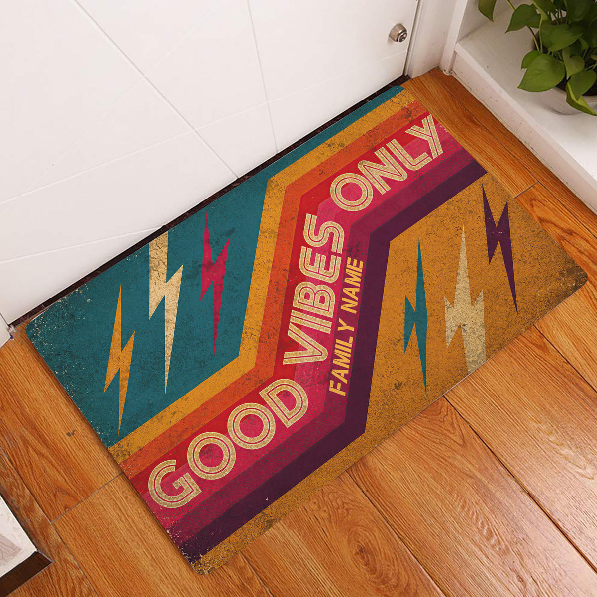 Colorful rock and roll doormat displayed at an indoor doorway on warm wood flooring
