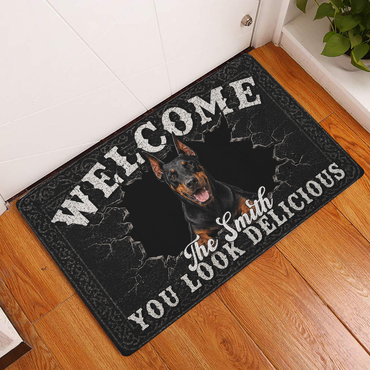 Doberman welcome doormat displayed at a front door on a warm wood floor