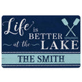 Navy and aqua lake house doormat with crossed oars, distressed wood accents and welcoming typography