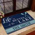 Lake house entryway rug styled near a glass door with crossed oars and blue rustic wood detailing