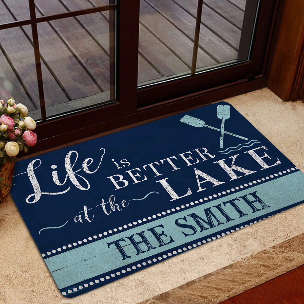 Lake house entryway rug styled near a glass door with crossed oars and blue rustic wood detailing