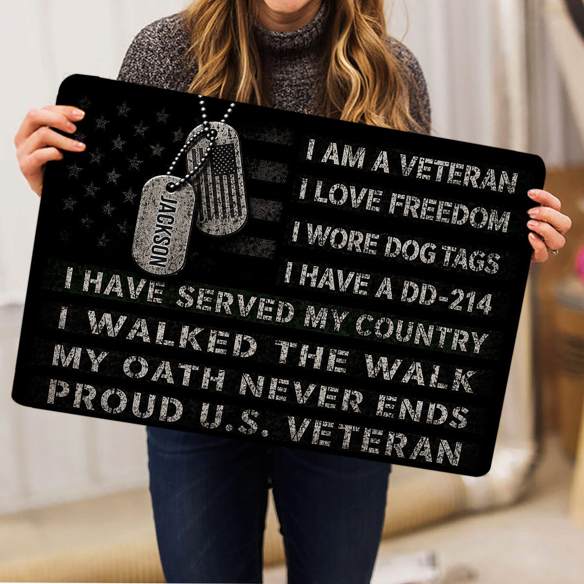 Person holding a patriotic veteran doormat featuring dog tags and bold tribute artwork