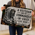 Person holding a veteran-themed doormat featuring combat boots, dog tags, flag detail, and bold tribute artwork