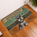 Miniature Schnauzer doormat styled at an indoor entryway beside a white door and wood floor