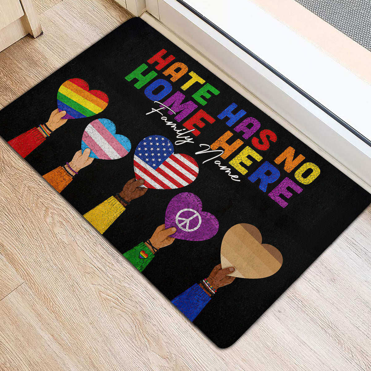 Colorful LGBT welcome mat placed beside a bright doorway with Pride heart designs