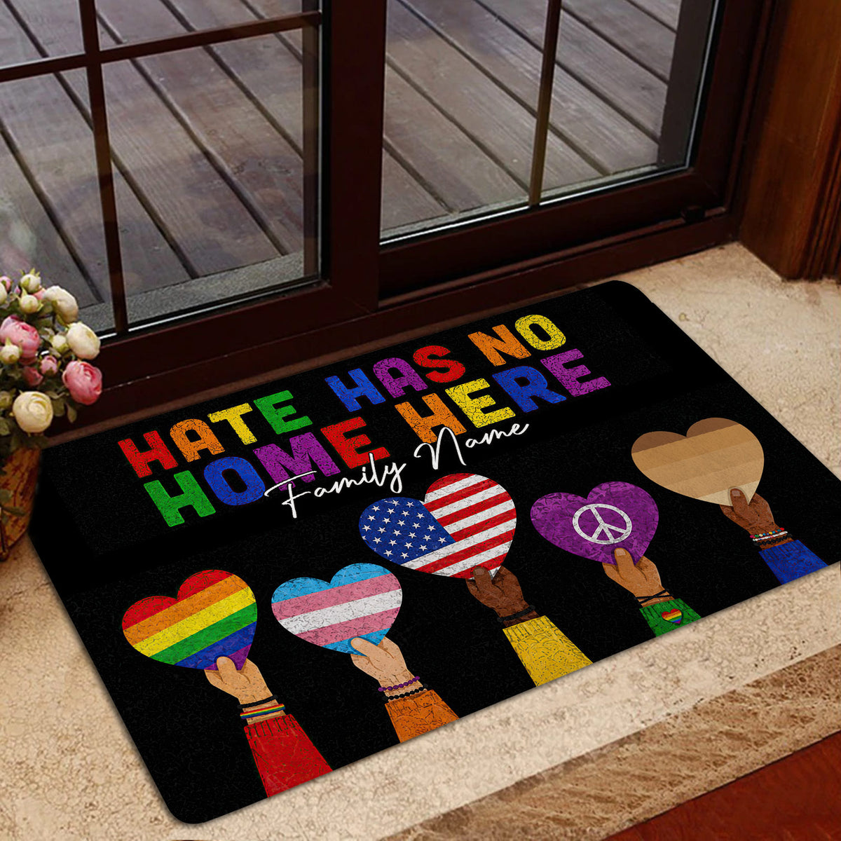 LGBT Pride entryway mat shown near a glass door with rainbow heart artwork