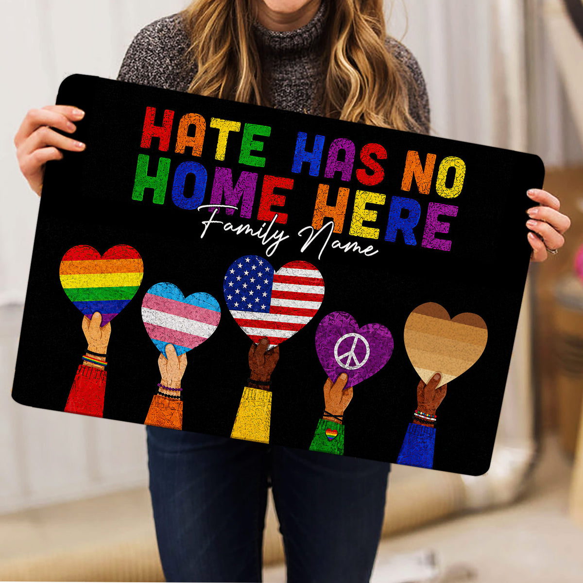 Black LGBT doormat displayed indoors with colorful Pride hearts and inclusive lettering