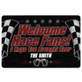 Black racing doormat with red and white lettering, checkered flags, stars, and beer mug artwork