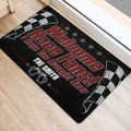 Black, red, and white racing door mat shown at an entryway with bold race-fan artwork