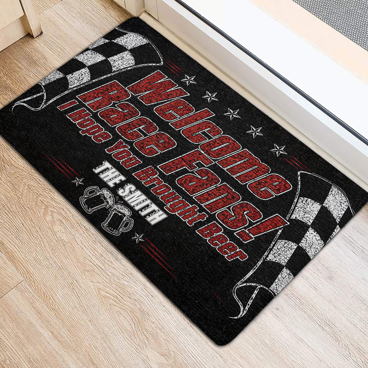 Black, red, and white racing door mat shown at an entryway with bold race-fan artwork