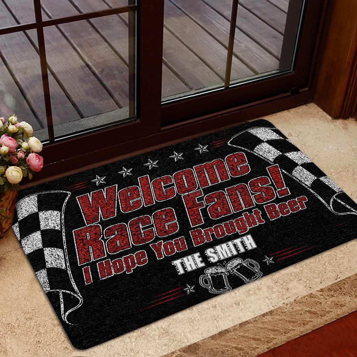 Racing doormat styled near a glass entrance with checkered flags and red motorsports graphics