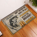 Fishing doormat displayed at an indoor entryway beside a white door on wood flooring